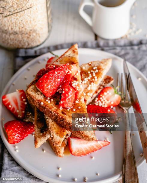 plate of french toast with strawberries, puffed quinoa and syrup - pain perdu ストックフォトと画像