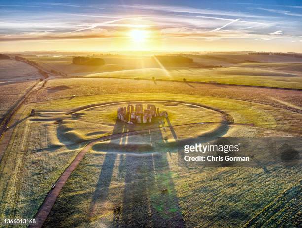 Drone point of view of the sun rising over Stonehenge on January 12,2022 in Wiltshire, England.