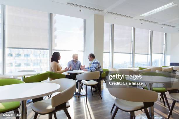 business people meeting in sunny office cafeteria - office canteen stock pictures, royalty-free photos & images