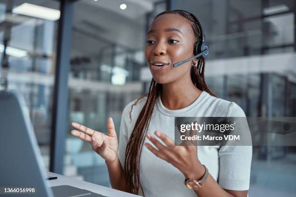 shot of a young female call center agent using a laptop at work - headset imagens e fotografias de stock