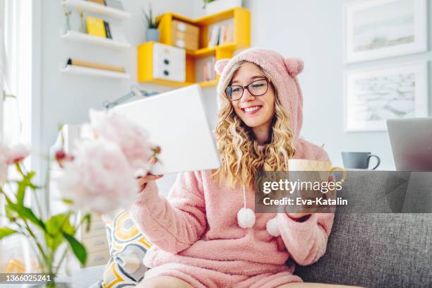 young woman at home - bear suit stock pictures, royalty-free photos & images