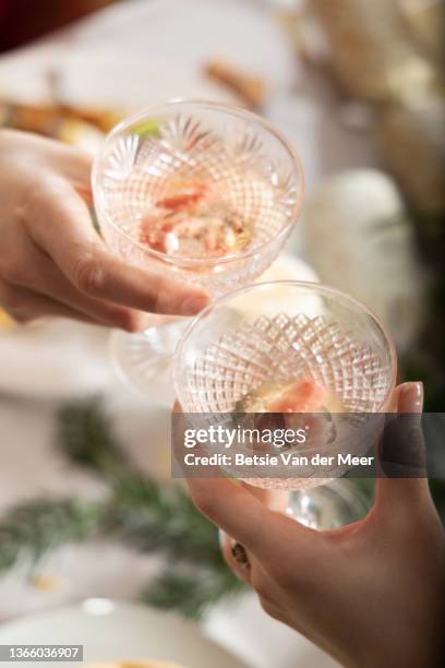 top shot of human hands making a toast with crystal glasses. - crystal glasses stockfoto's en -beelden