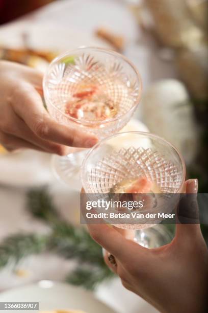 top shot of human hands making a toast with crystal glasses. - crystal glasses bildbanksfoton och bilder