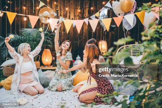 group of girlfriends dancing at the backyard party. - girls night out stockfoto's en -beelden