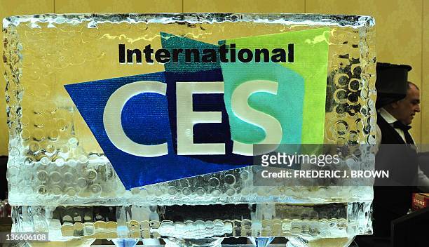 Waiter walks past a block of ice with event logo at CES Unveiled, ahead of the opening of the annual Consumer Electronics Show on January 8, 2012 in...