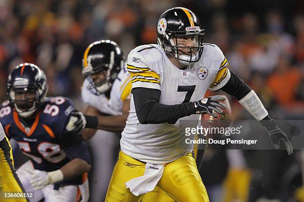 Quarterback Ben Roethlisberger of the Pittsburgh Steelers scrambles with the ball as linebacker Von Miller of the Denver Broncos pursues the play at...