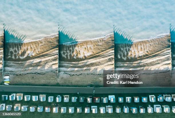 an elevated daytime view of beach huts and beach - kent coastline stock pictures, royalty-free photos & images