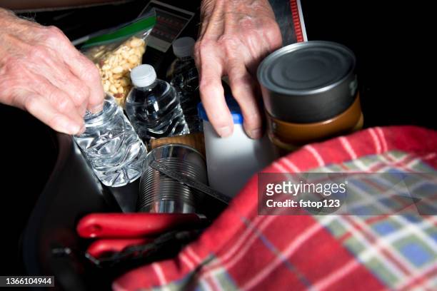 lv senior man prepares for roadside emergency with survival items in his truck. - hurricane preparation stock pictures, royalty-free photos & images