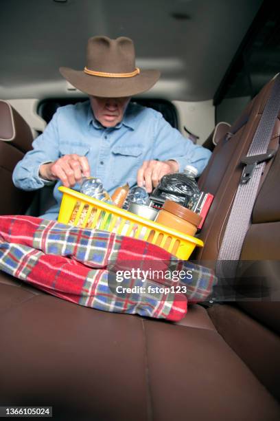 lv senior man prepares for roadside emergency with survival items in his truck. - emergency planning stock pictures, royalty-free photos & images