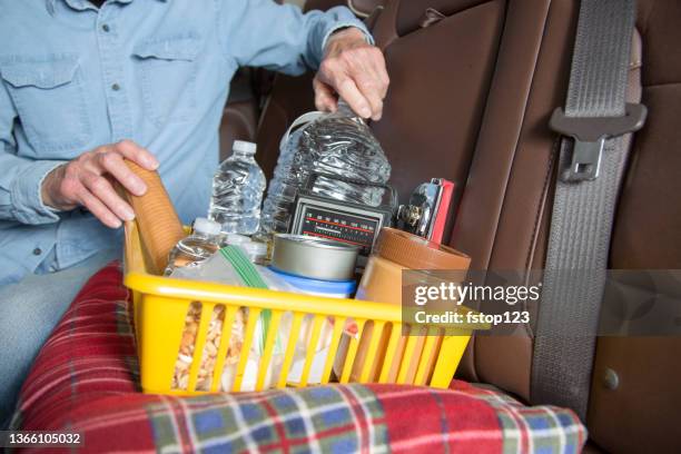 lv senior man prepares for roadside emergency with survival items in his truck. - hurricane preparation stock pictures, royalty-free photos & images