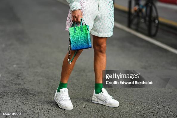 A guest wears white mesh with green LV monogram print pattern