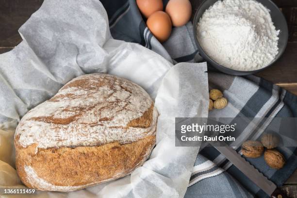 top view of homemade round loaf bread with flour and ingredients - round loaf stock pictures, royalty-free photos & images
