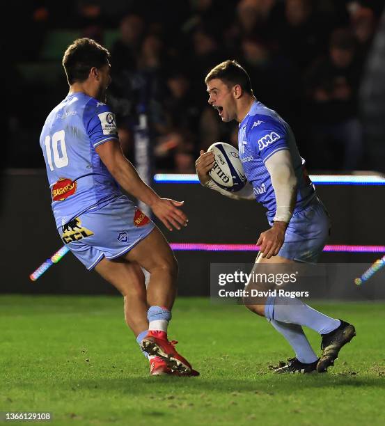 Rory Kockott of Castres celebrates with team mate Ben Botica after scoring their third try during the Heineken Champions Cup match between Harlequins...