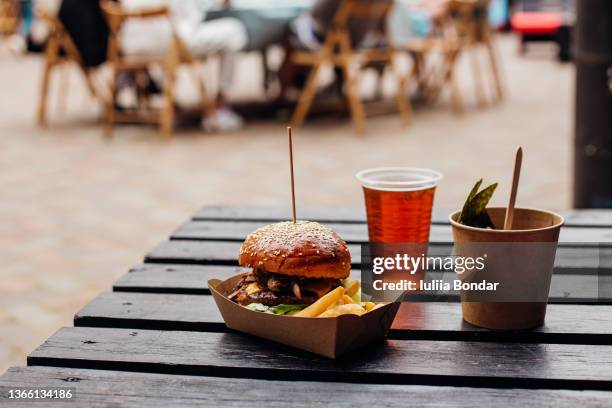 burger on a wooden table outdoor - street food market stock pictures, royalty-free photos & images