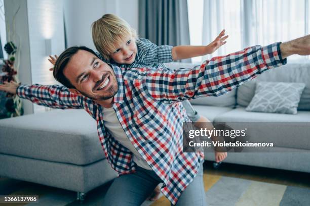 father and little son at home. - flying dad son stock pictures, royalty-free photos & images