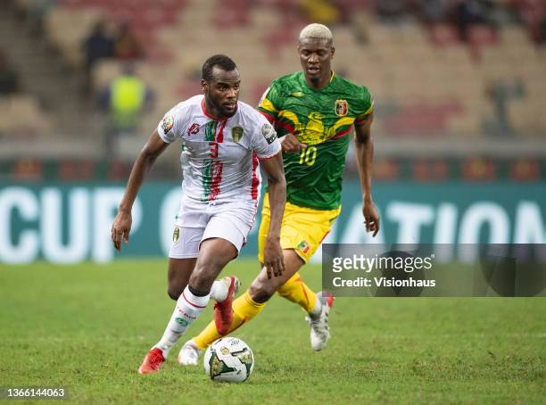 Of Mauritania and KALIFA COULIBALY of Mali during the Group F Africa Cup of Nations 2021 match between Mali and Mauritania at Stade de Japoma in...