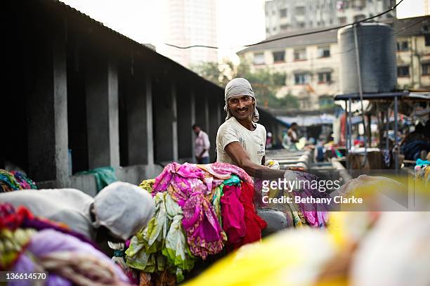 Laundry worker washes clothes at Dhobi Ghat on November 4, 2011 in Mumbai, India. Dhobi Ghat is known as the world's largest laundry with 800 wash...