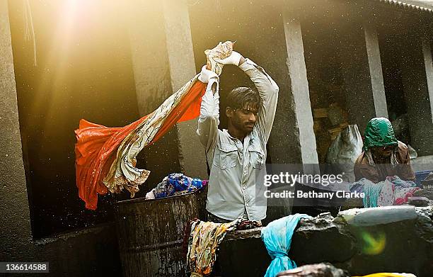 Laundry workers flogs clothes at Dhobi Ghat on November 4, 2011 in Mumbai, India. Dhobi Ghat is known as the world's largest laundry with 800 wash...