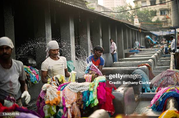 Laundry workers wash clothes at Dhobi Ghat on November 4, 2011 in Mumbai, India. Dhobi Ghat is known as the world's largest laundry with 800 wash...