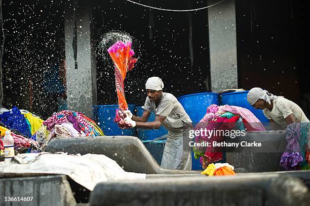 Laundry workers flog clothes at Dhobi Ghat on November 4, 2011 in Mumbai, India. Dhobi Ghat is known as the world's largest laundry with 800 wash...