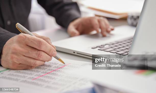 a accountant analyzing investment chart - commercialista foto e immagini stock