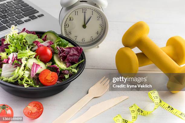 healthy food and diet concept. - orange alarm clock stock pictures, royalty-free photos & images