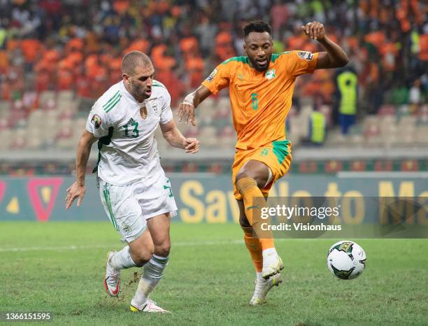 Of Algeria and WILFRIED KANON of Ivory Coast during the Group E Africa Cup of Nations 2021 match between Ivory Coast and Algeria at Stade de Japoma...