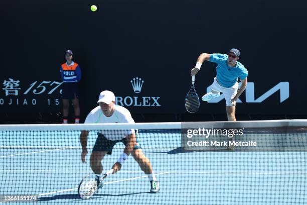 Dominic Inglot of Great Britain serves in his second round doubles match against Raven Klaasen of South Africa and Ben McLachlan of Japan during day...