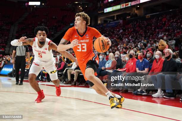 Coleman Hawkins of the Illinois Fighting Illini dribbles by Eric Ayala of the Maryland Terrapins in the first half during a college basketball game...