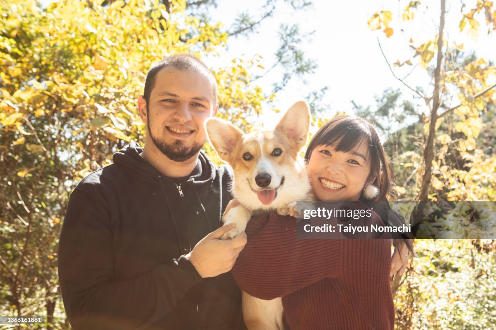 An internationally married couple and their pet corgi dog