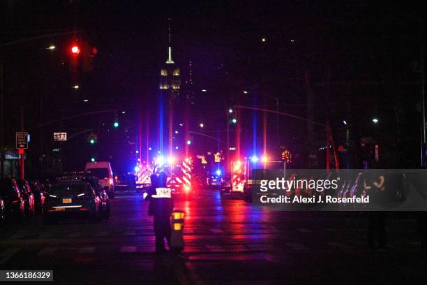 Ambulances leave Harlem Hospital with a view of the Empire State Building in the background on January 21, 2022 in New York City. One officer was...