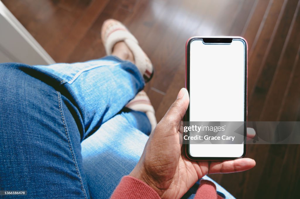Woman Holds Smart Phone With Blank Screen
