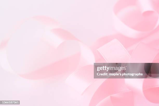 satin ribbon,pink background - thin ribbon stock pictures, royalty-free photos & images