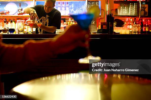 Waiter prepares a cocktail at "Museo Chicote" on January 6, 2012 in Madrid, Spain. Opened by Perico Chicote in 1931, the "Museo Chicote" is one of...