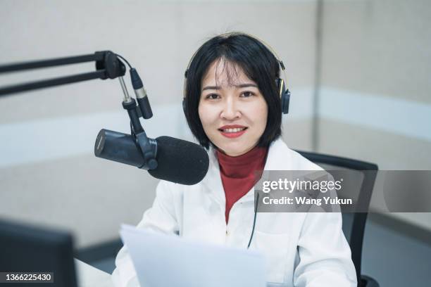 a young female presenter is broadcasting a live broadcast on a radio station - radio host stock pictures, royalty-free photos & images