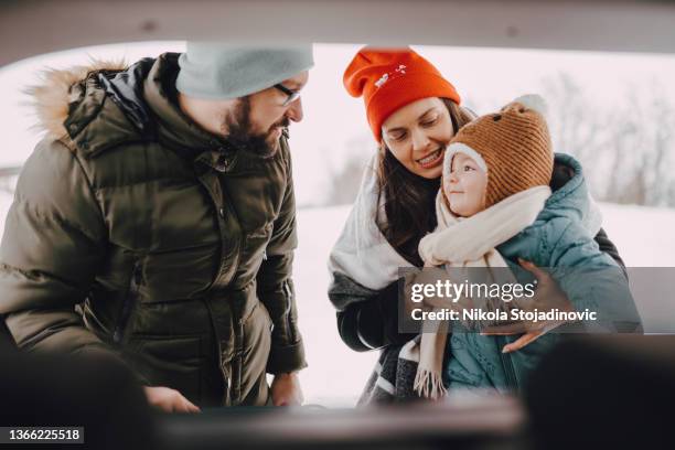 the family takes the sled out of the car - baby boot stock pictures, royalty-free photos & images