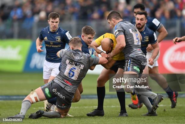 Referee, Andrea Piardi gets tangled in a tackle as Garry Ringrose of Leinster is tackled by Tom Ellis and Charlie Ewels of Bath during the Heineken...