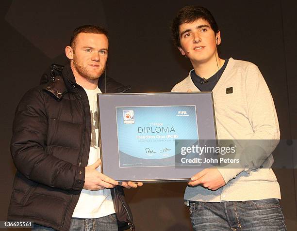 Wayne Rooney of Manchester United poses with the winner of a FIFA12 interactive tournament at the FIFA Ballon d'Or Gala 2011 at FIFA Kongresshaus on...