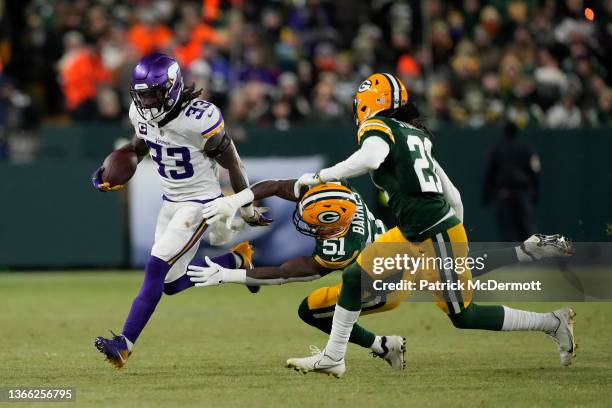 Dalvin Cook of the Minnesota Vikings runs with the ball against Krys Barnes of the Green Bay Packers in the first half at Lambeau Field on January...