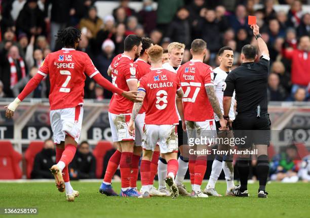 Ravel Morrison of Derby County is shown a red card during the Sky Bet Championship match between Nottingham Forest and Derby County at City Ground on...