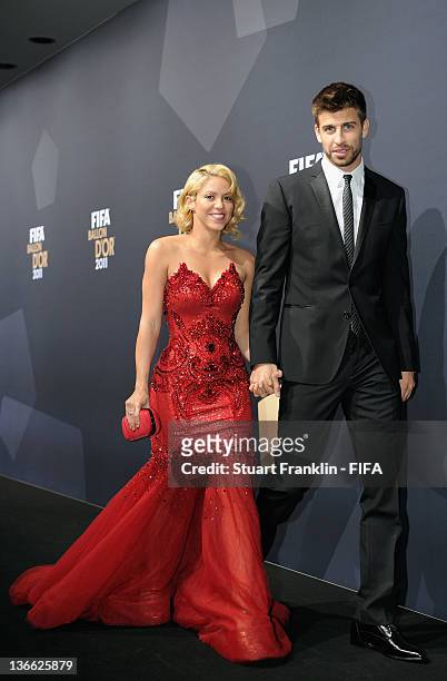 Pop star Shakira and Gerard Pique of Barcelona pose for photos after arriving at the FIFA Ballon d'Or Gala 2011 at the Kongresshaus on January 09,...