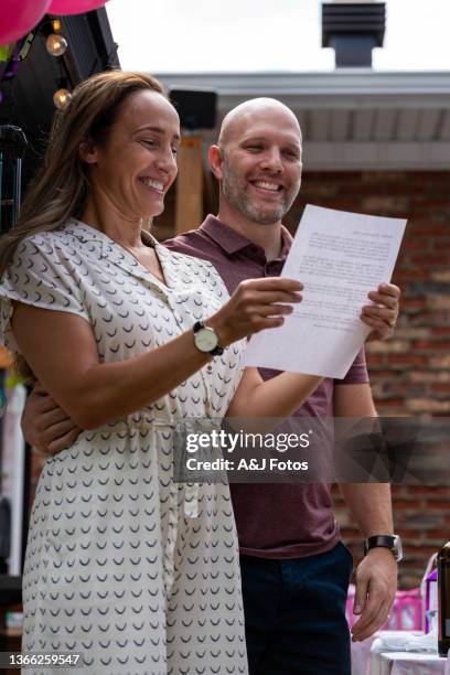 couple doing a speech during a family celebration. - memorial garden stock pictures, royalty-free photos & images