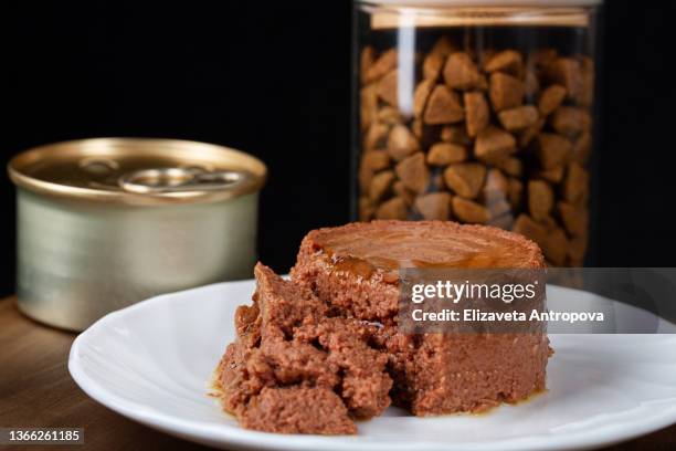 canned soft pet food on dark background - pate foto e immagini stock