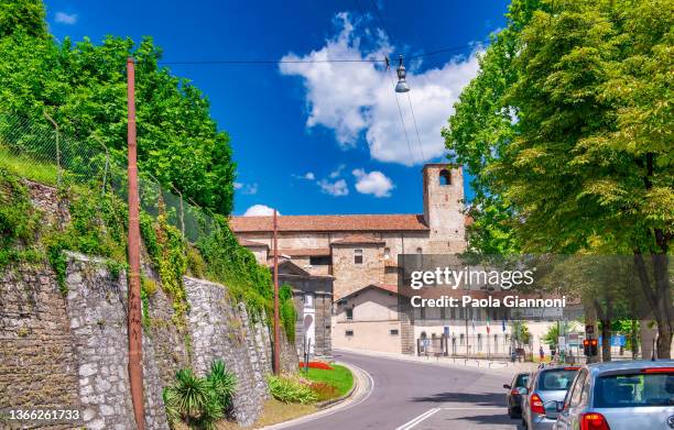 city streets and buildings of bergamo alta with tourists on a sunny day. - bergamo alta stock pictures, royalty-free photos & images