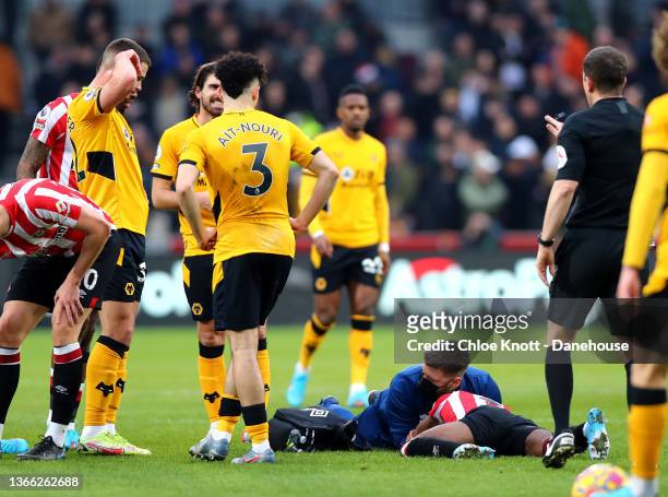Rico Henry of Brentford recieves medical attention during the Premier League match between Brentford and Wolverhampton Wanderers at Brentford...