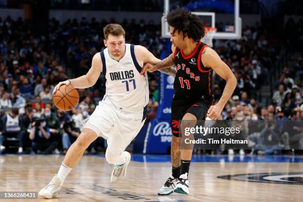 Luka Doncic of the Dallas Mavericks drives to the basket against Justin Champagnie of the Toronto Raptors in the first half at American Airlines...