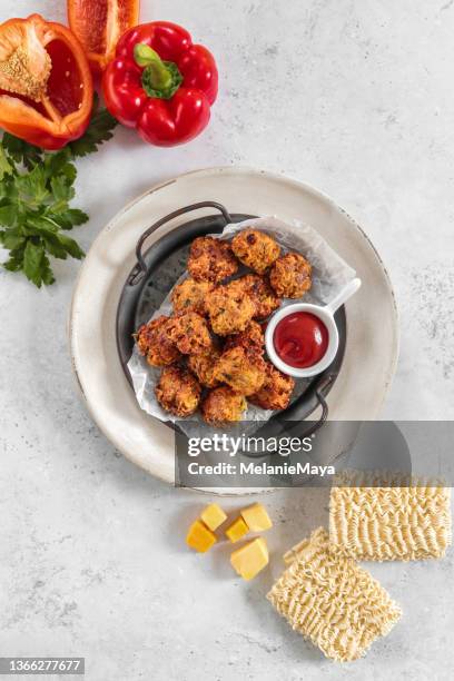 homemade snack cheese balls fritters with cheddar and veggies and ramen noodles - cheese ball stock pictures, royalty-free photos & images