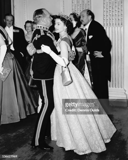Queen Elizabeth II dancing with Air Marshal Sir John Baldwin , colonel of the 8th Hussars, at a ball held at the Hyde Park Hotel, London, 26th...