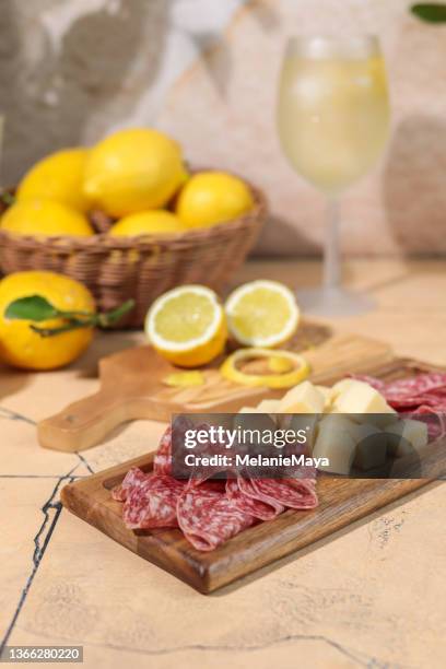 italian charcuterie cheese board mediterranean style with lemons - summer sausage stock pictures, royalty-free photos & images