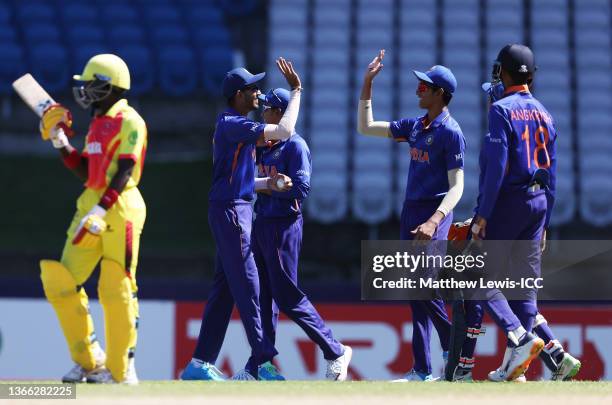 Vicky Ostwal of India celebrates with team mates after taking a catch to dismiss Brian Asaba of Uganda during the ICC U19 Men's Cricket World Cup...